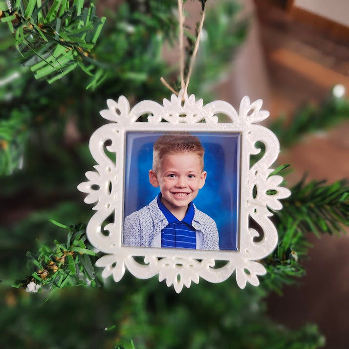 Personalized Custom photo magnet in a white ornament on christmas tree.